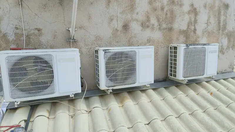 Três condensadoras instaladas lado a lado sobre o telhado